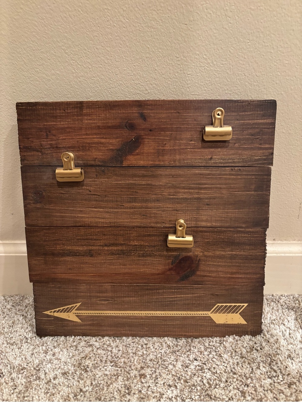 Wooden square decor with three gold clips to hold photos.